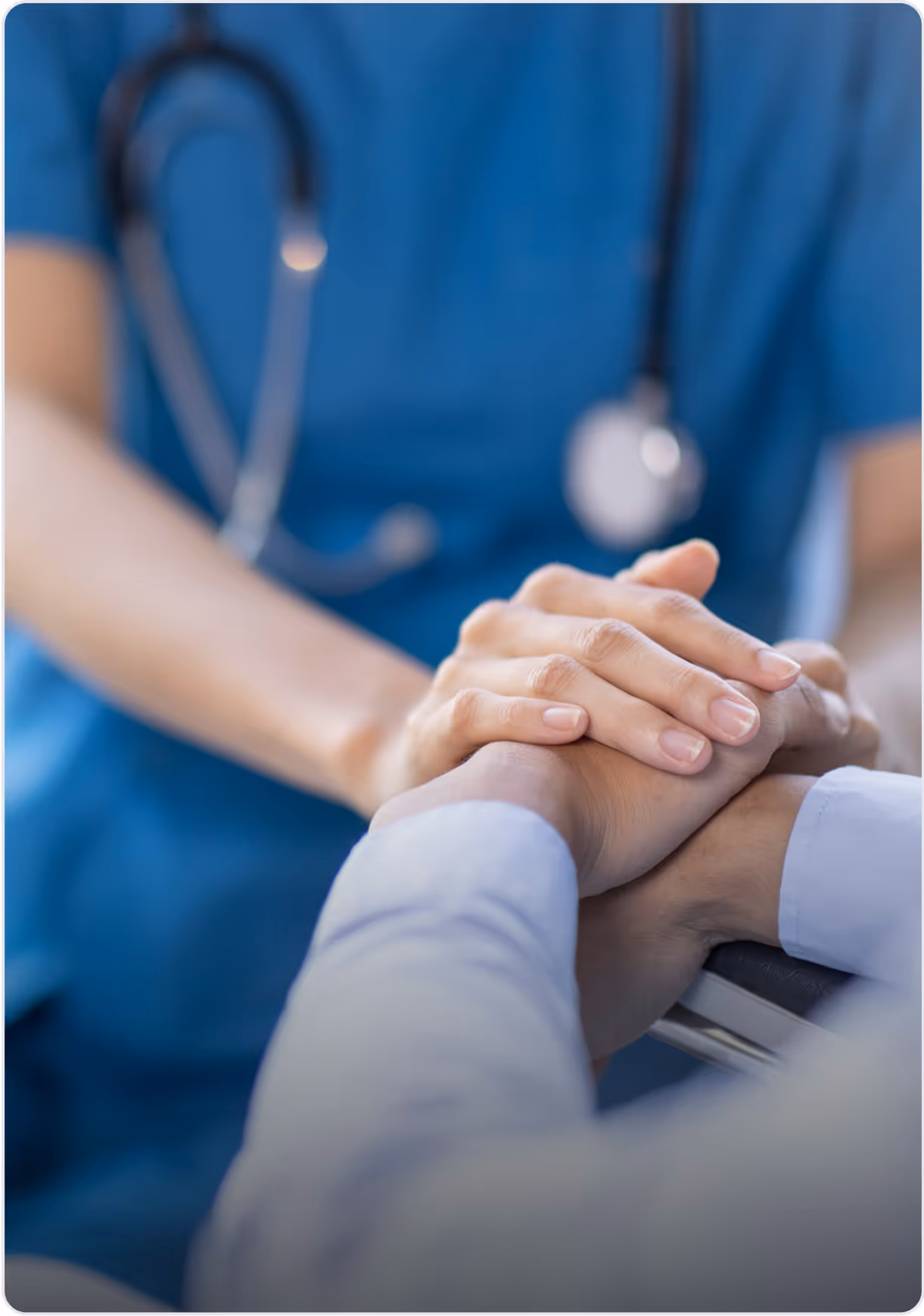 A medical professional holding the hands of a patient.