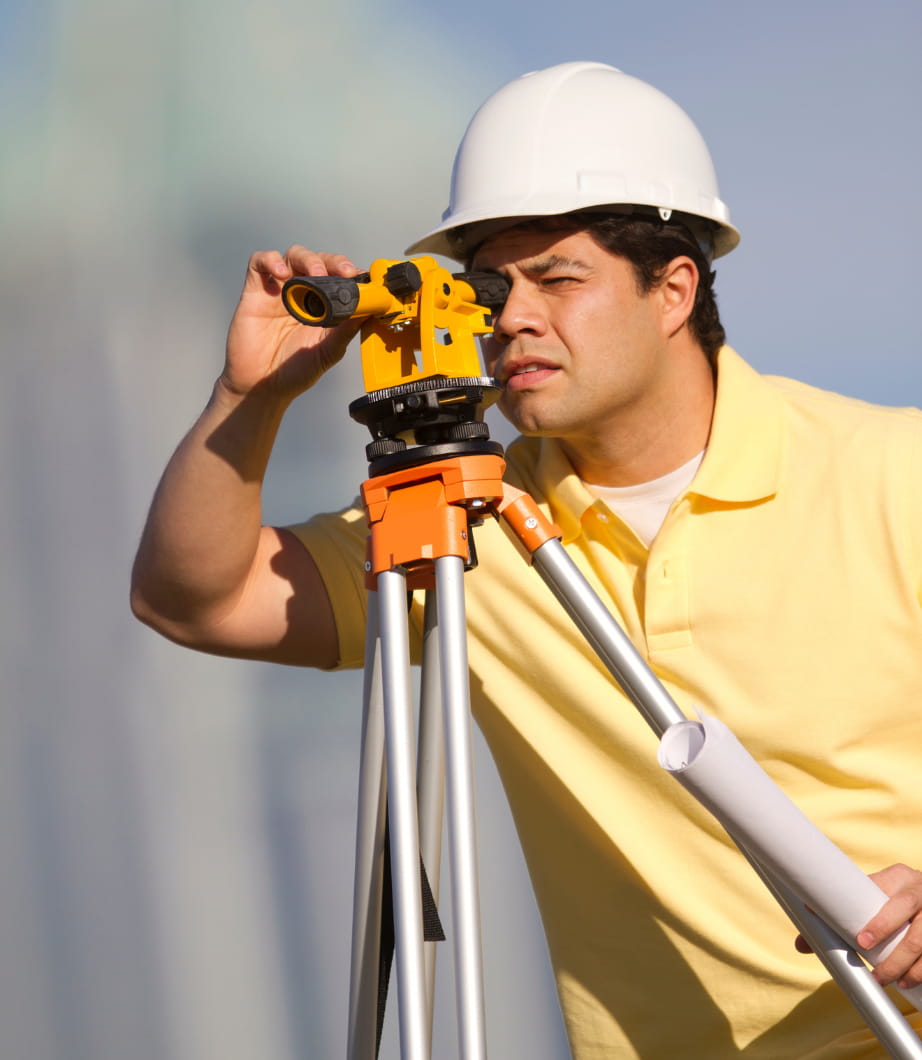 a surveyor using his tool