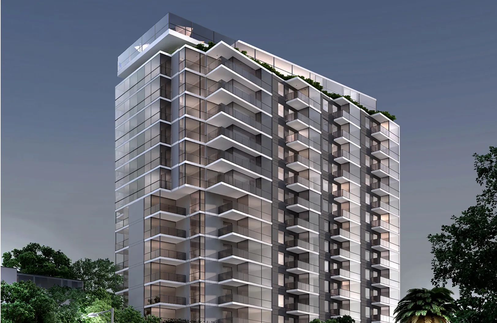 A modern high-rise apartment building with glass balconies and illuminated interiors, seen at dusk with some greenery in the foreground.