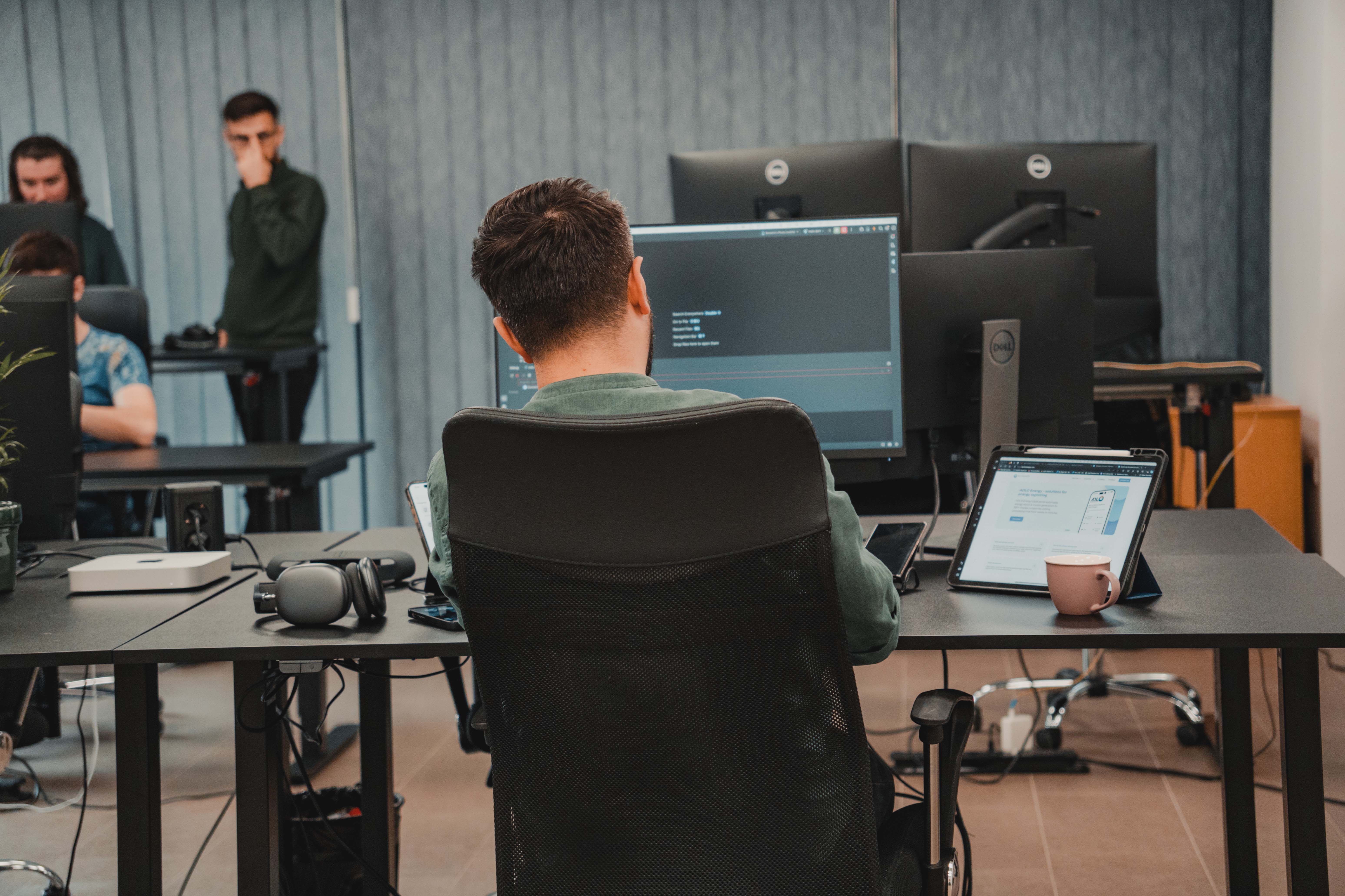 person working at a desk in an office photographed from behind