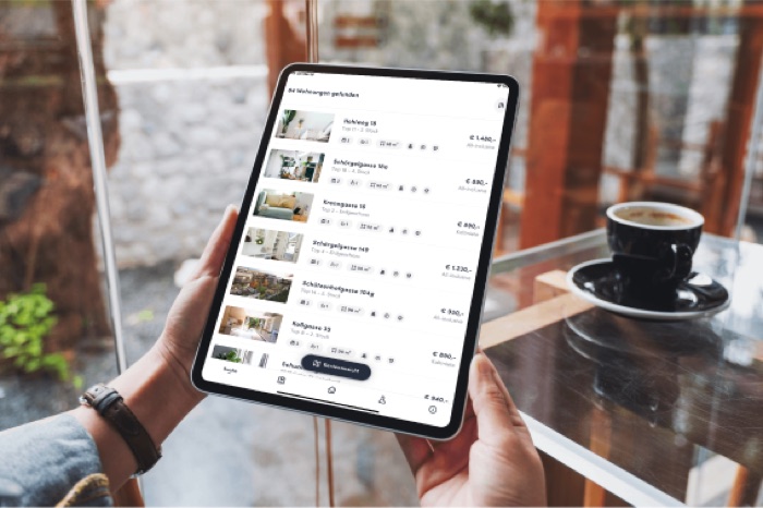 Apartment management app open on a tablet showing rental listings