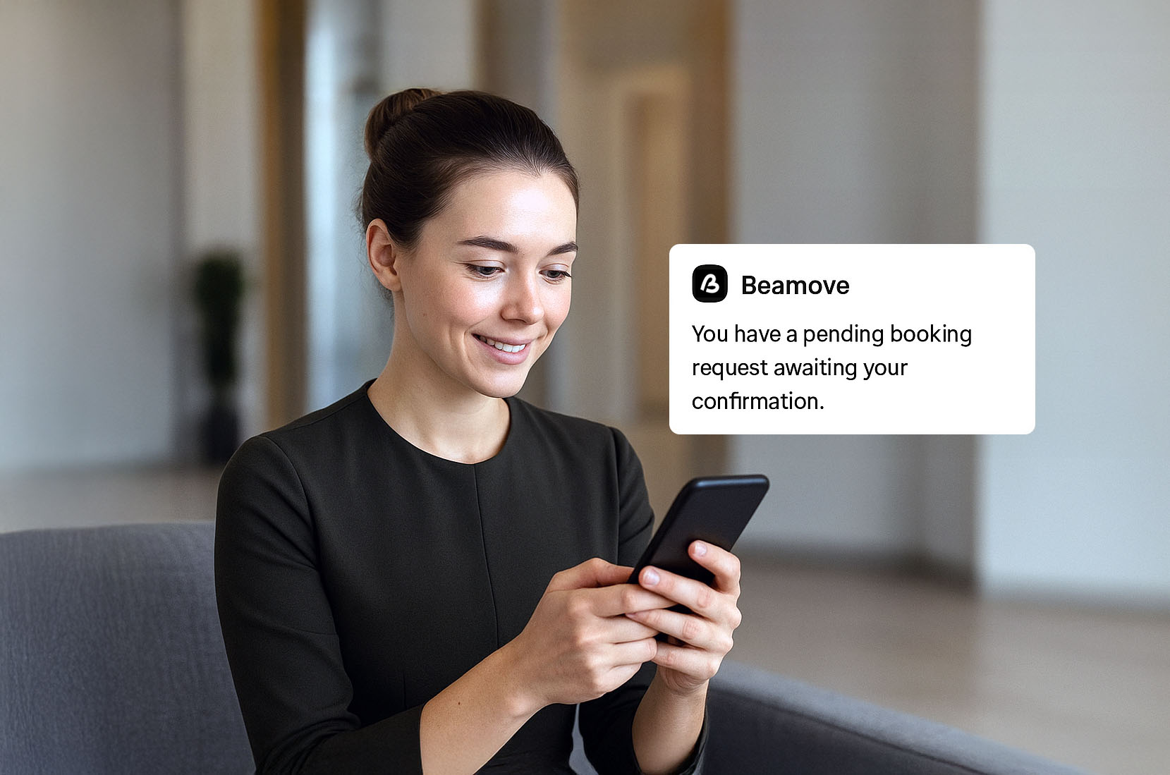 Smiling woman sitting on a chair and looking at her smartphone with a notification about a pending booking request from Beamove.