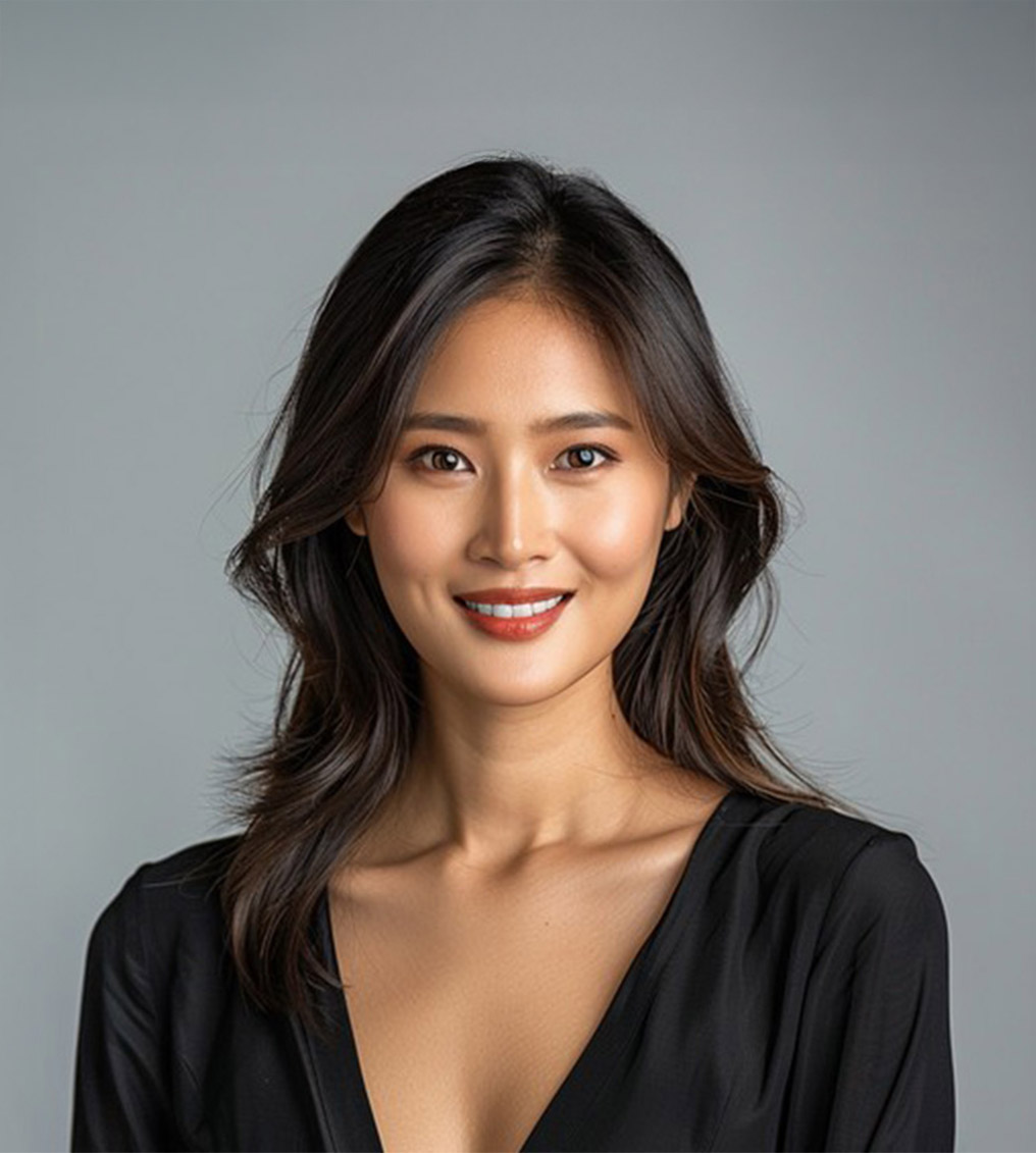 Young woman with colorful rainbow eyeshadow and glossy lips holding a container of makeup brushes.