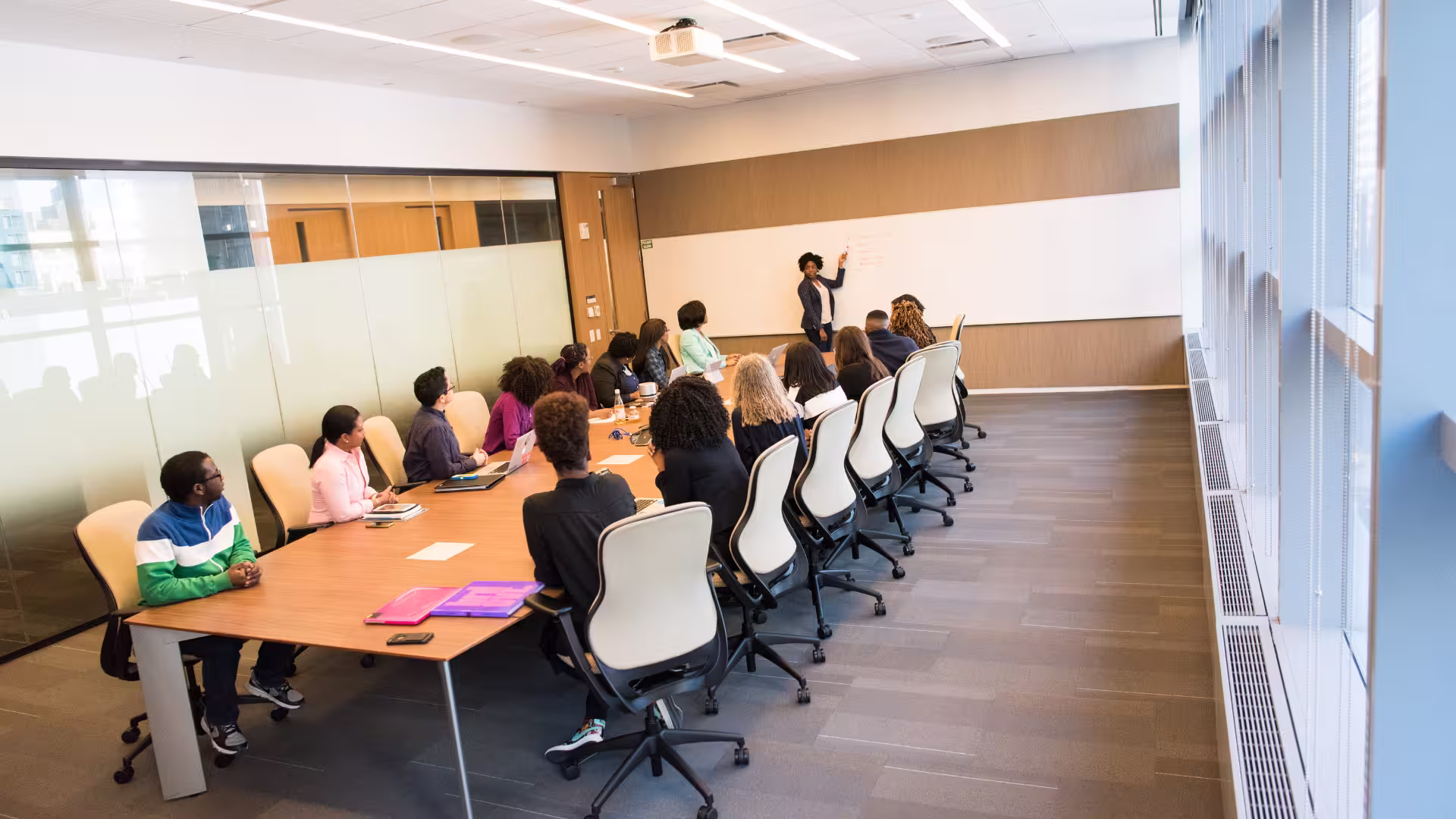 Woman on a whiteboard in an okr meeting