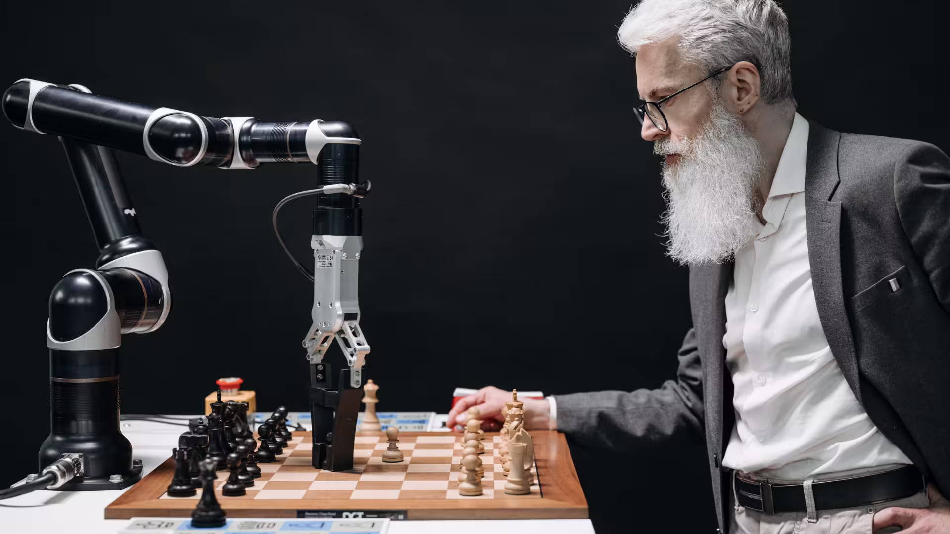 Man playing Chess with a machine to illustrate working with an AI