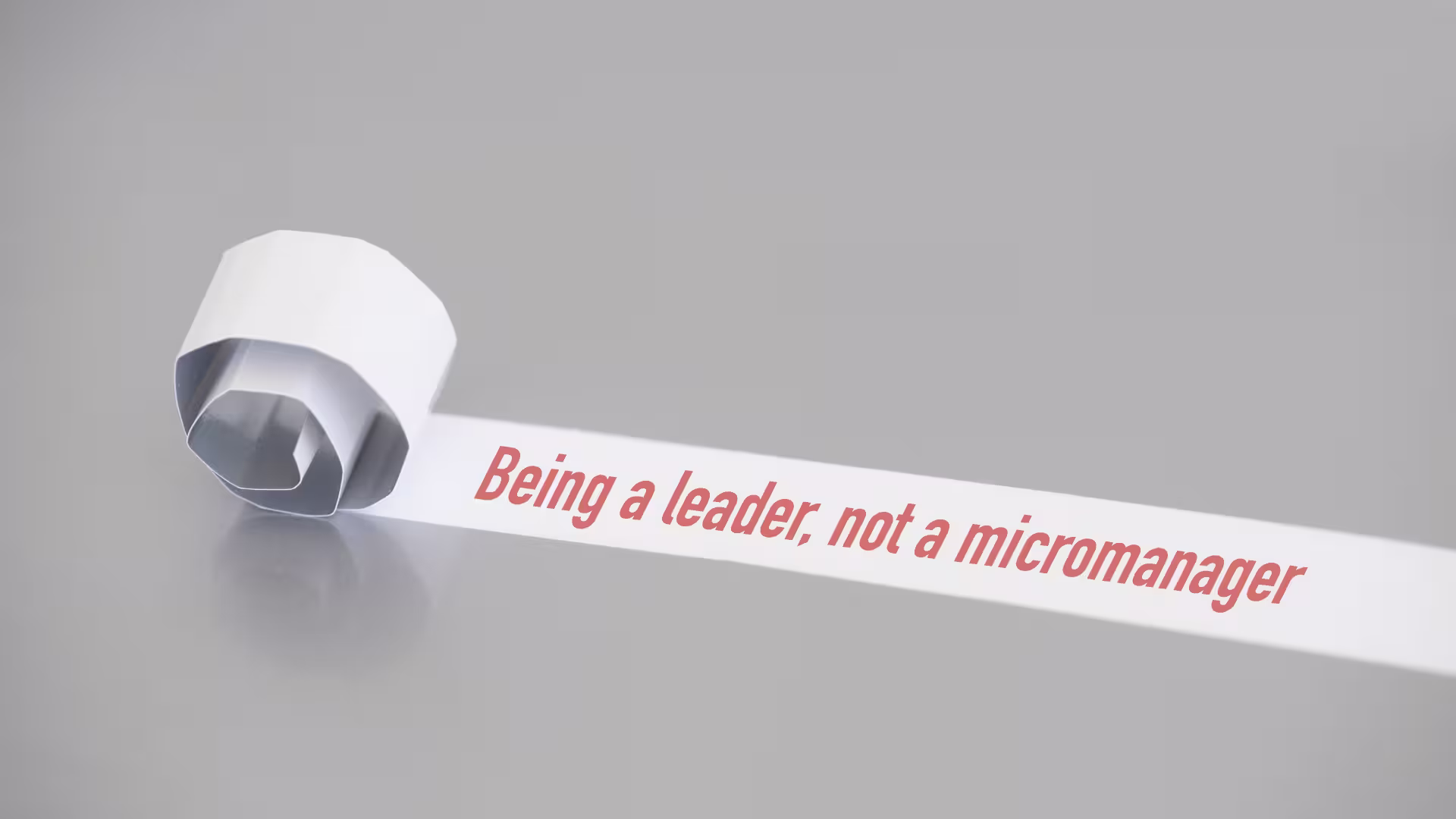 "Being a leader, not a micromanager" written on a paper roll