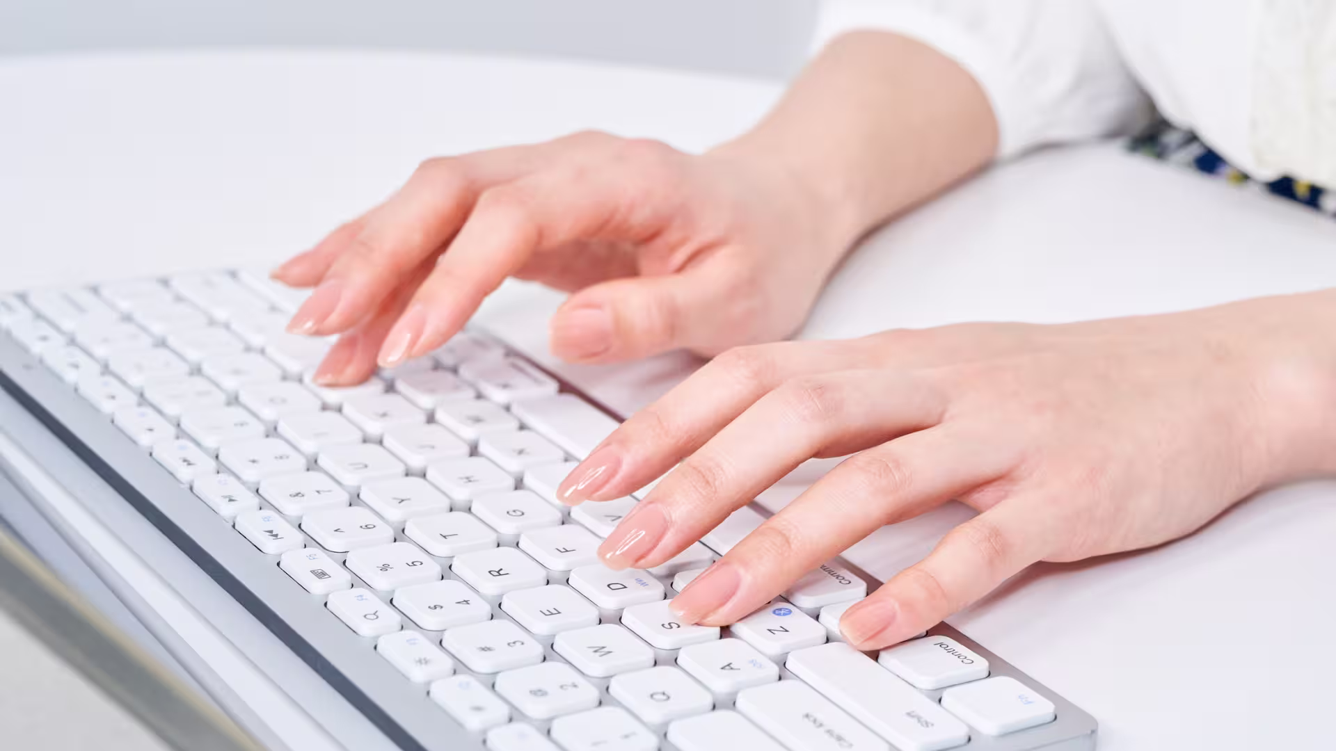 woman writing a message on a keyboard