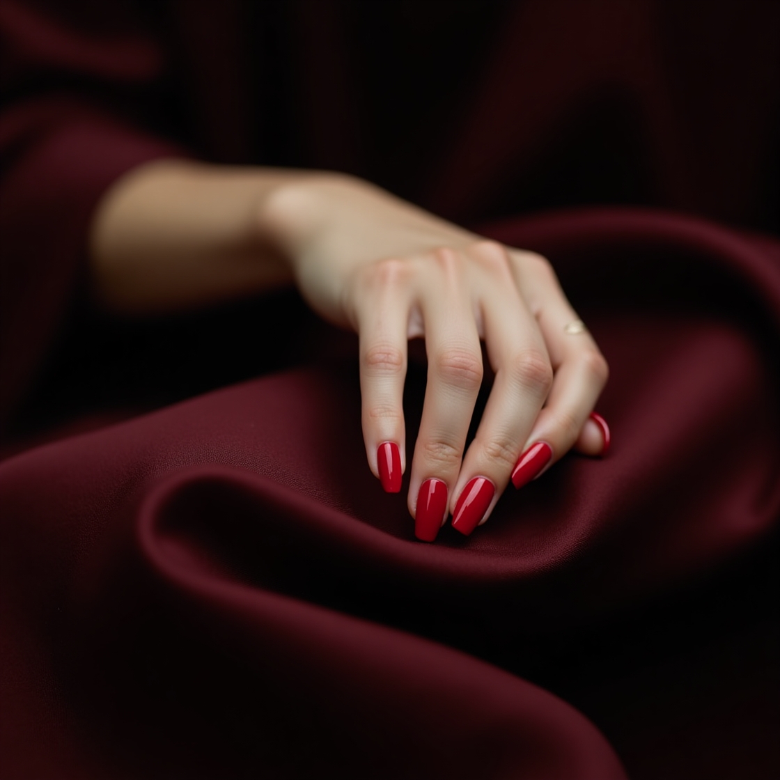 Classic Velvet Red nail polish on neatly manicured nails — bold and timeless.