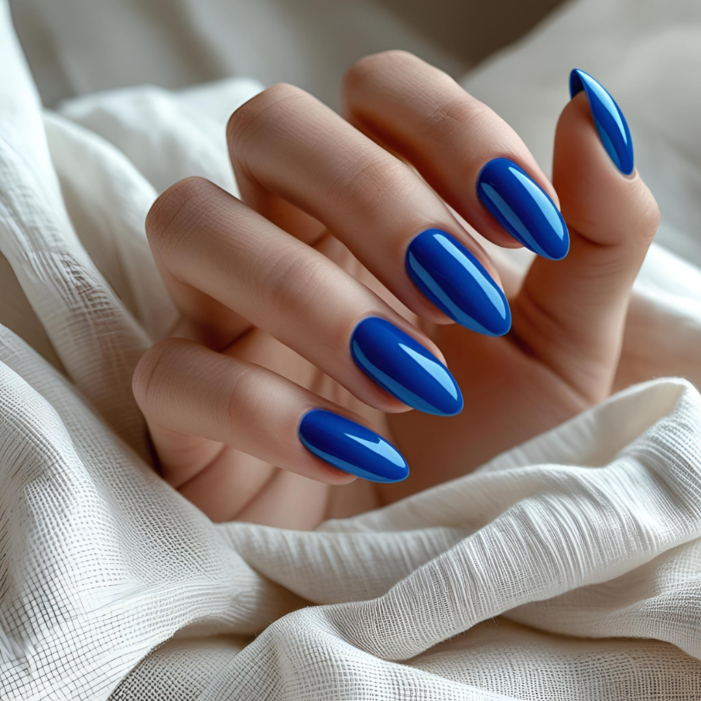 Electric blue Cobalt Rush nail polish on a hand — edgy and eye-catching.