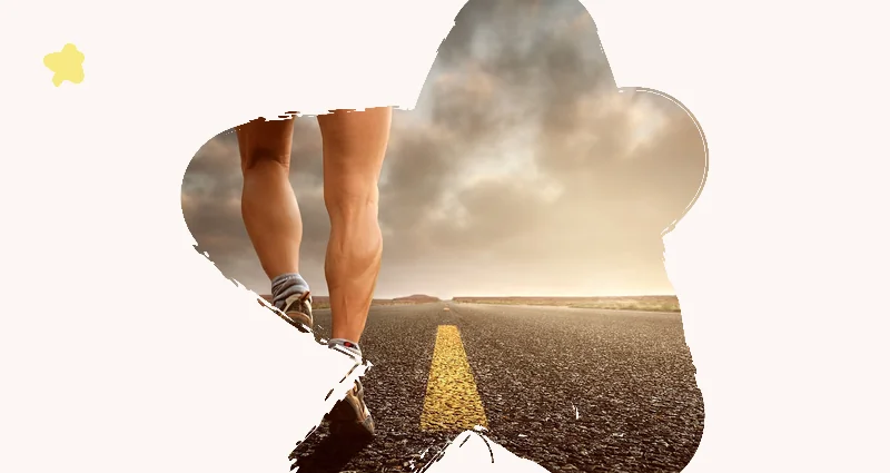 Runner's legs on an open road under a cloudy sky.