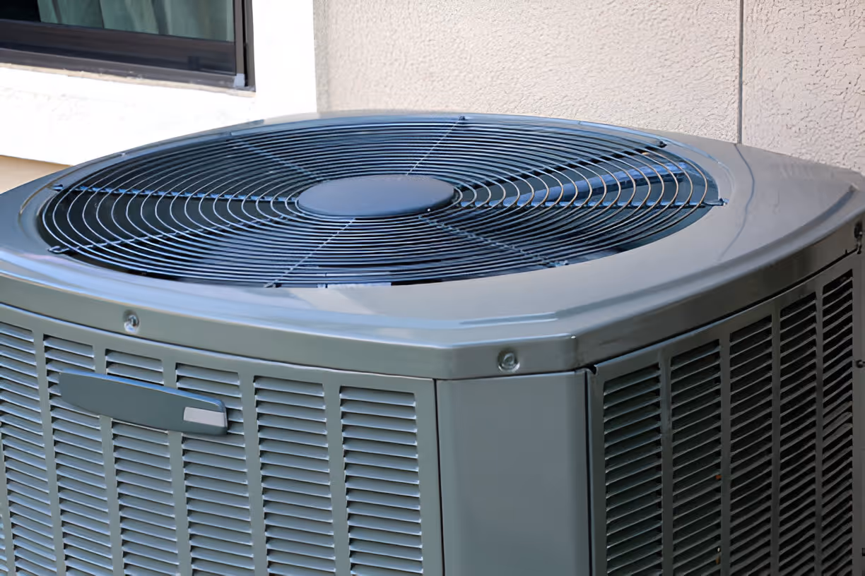 Green air conditioning unit with large circular fan outside building