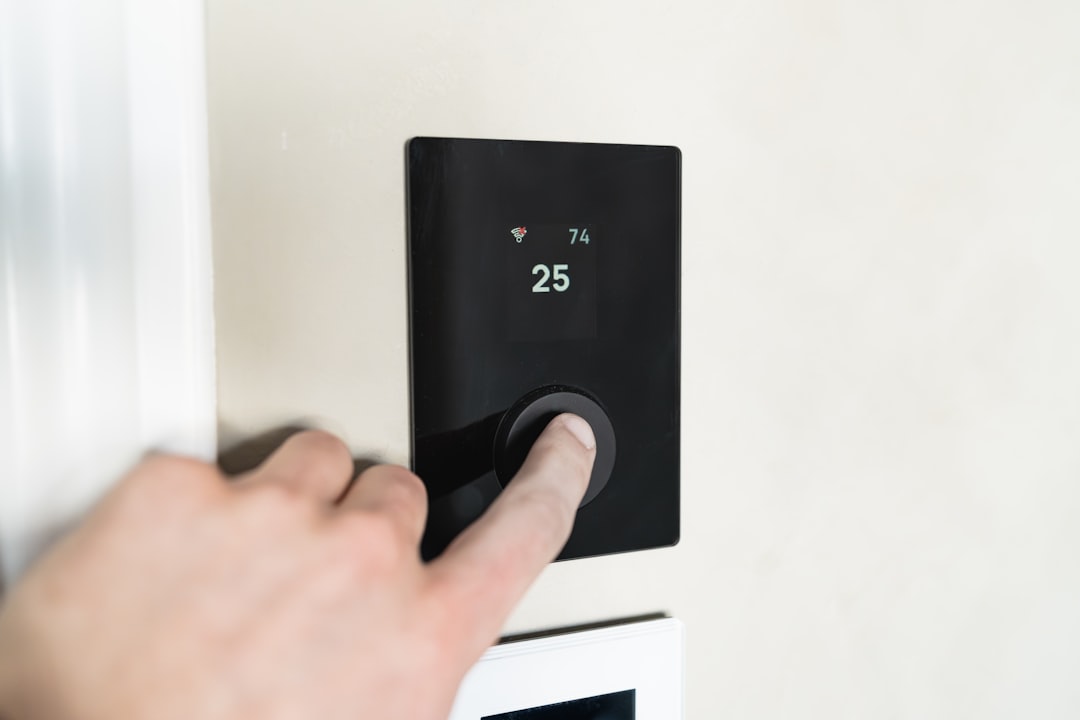 homeowner checking a thermostat in a Langley BC residence - signs your ac needs repair homeowner checking a thermostat in a Langley BC residence - signs your ac needs repair