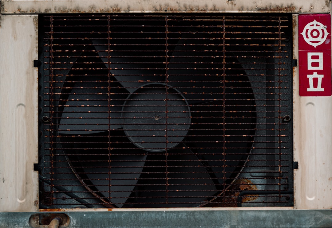 technician cleaning outdoor condenser coils with specialized brush technician cleaning outdoor condenser coils with specialized brush