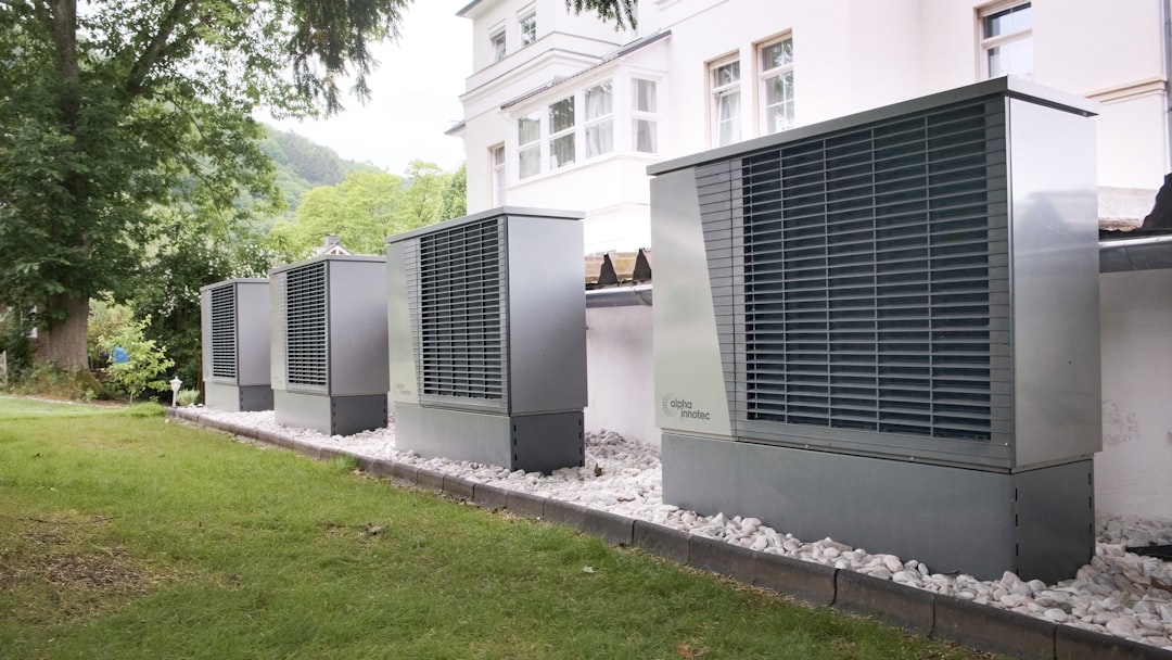 air conditioning unit running efficiently outdoors near green foliage air conditioning unit running efficiently outdoors near green foliage