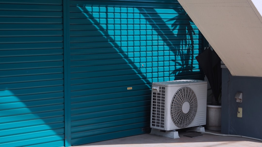 An outdoor condenser unit clear of debris and surrounded by tidy landscaping An outdoor condenser unit clear of debris and surrounded by tidy landscaping