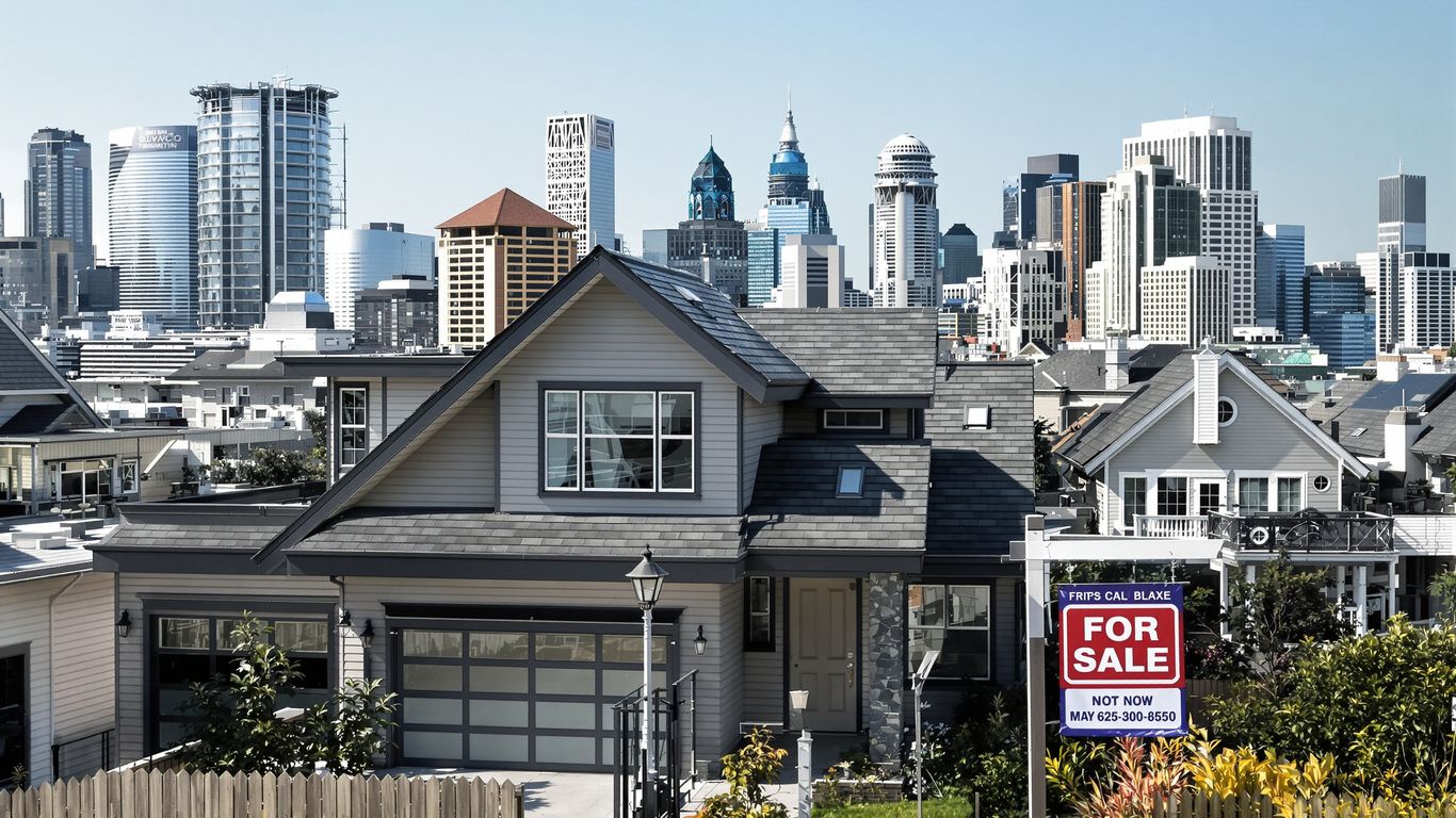Modern house with city skyline backdrop.