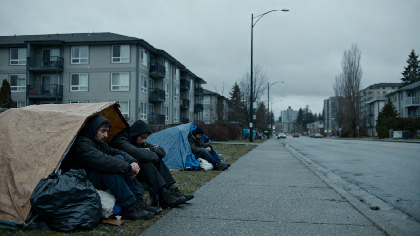 Abbotsford street with homeless individuals and apartment buildings.