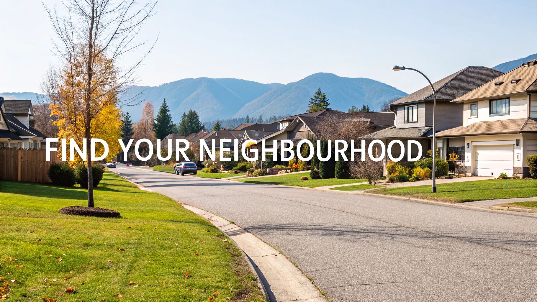 A scenic view of a residential neighbourhood in Mission, BC, with mountains in the background.
