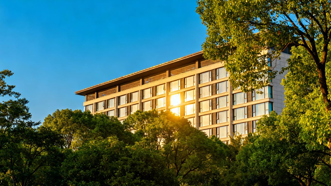 Hotel building with trees and blue sky.