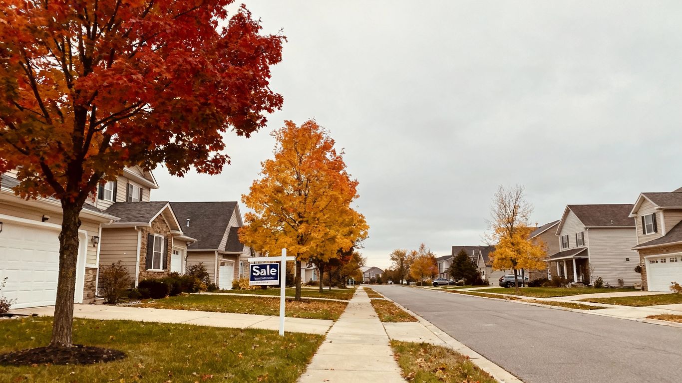 Suburban houses on a street with overcast sky.