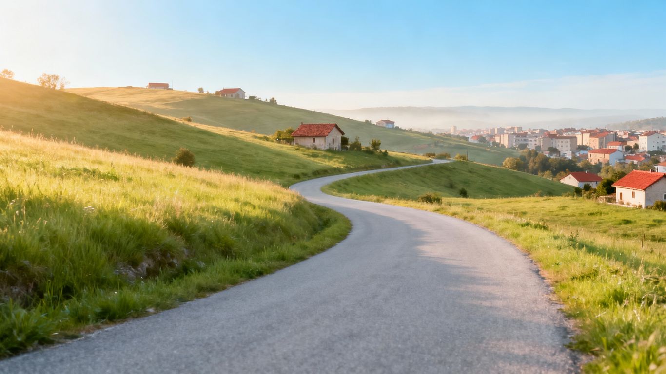 Houses and rolling hills in a quiet, scenic town.