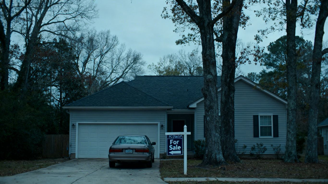 House for sale with overcast sky.