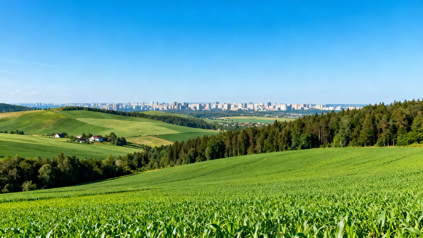 Green farmland meeting urban development in British Columbia.