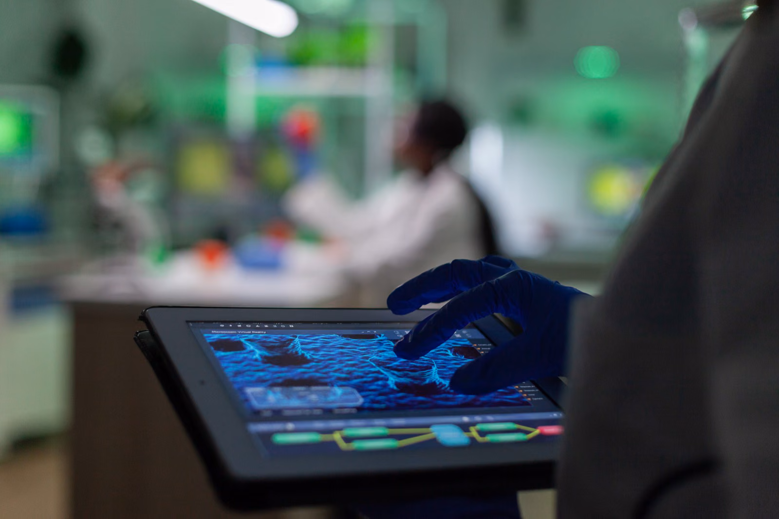 Gloved hand reviewing medical imaging analysis on a tablet in a clinical laboratory