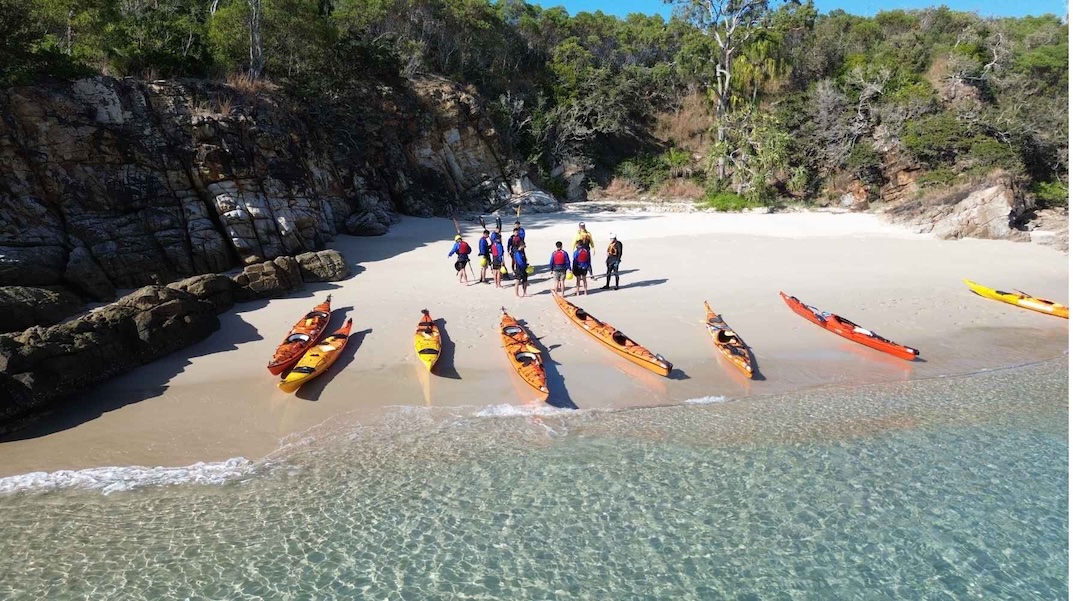 Team preparing for a sea kayaking team building program on North Keppel Island, Queensland