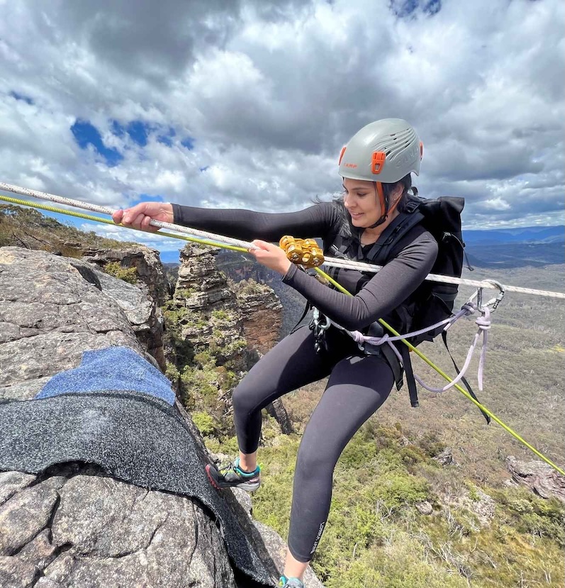 Participant focused during a rope traverse in a corporate team cohesion program in the Blue Mountains near Sydney