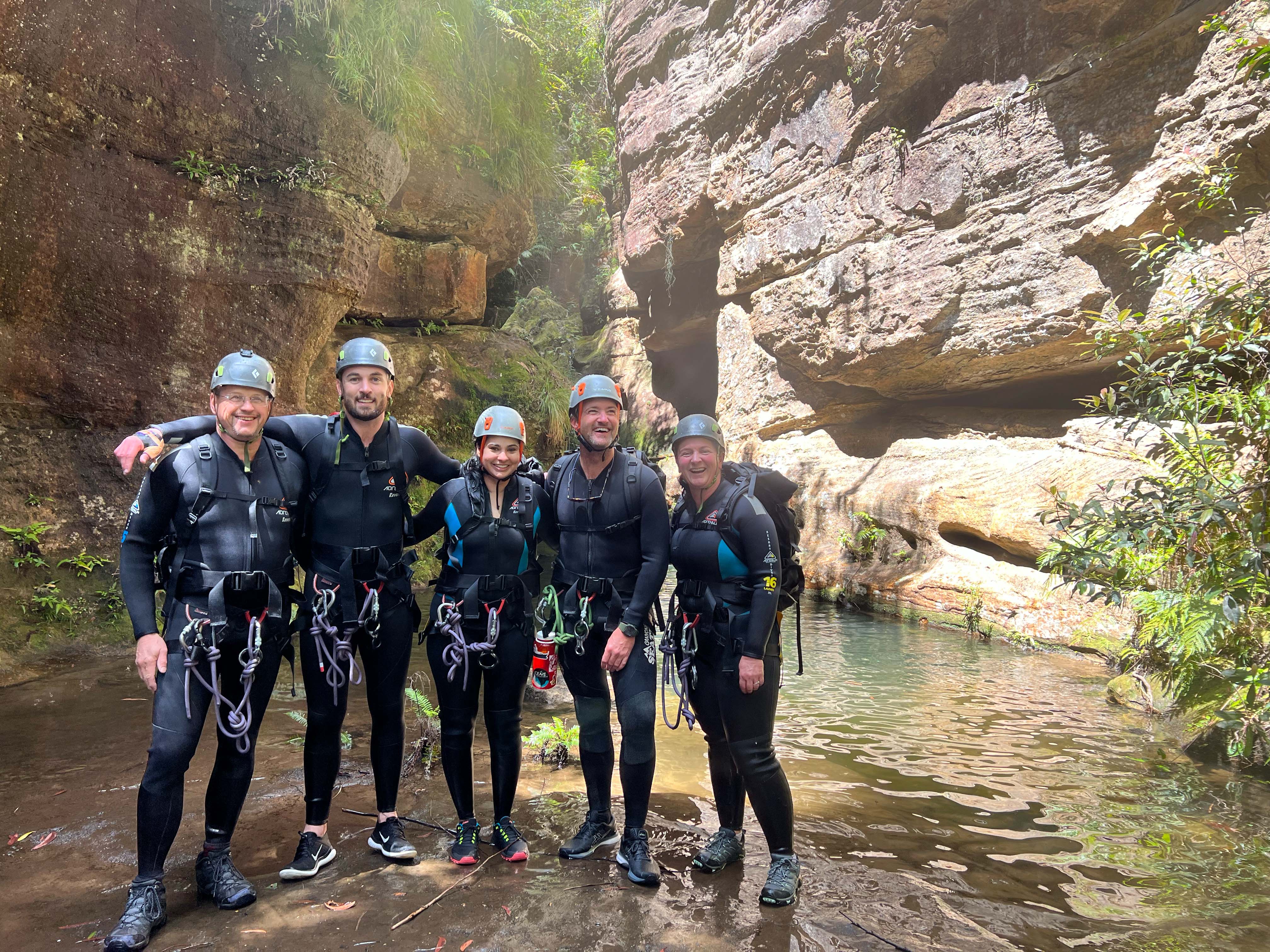 Team participating in canyoning during a team cohesion activity in the Blue Mountains near Sydney