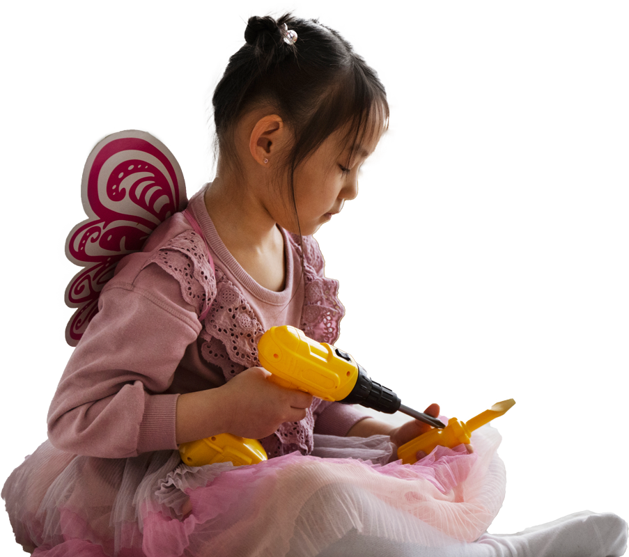Girl playing fairy dress up with a toy drill