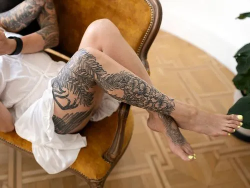 high angle tattooed people couch