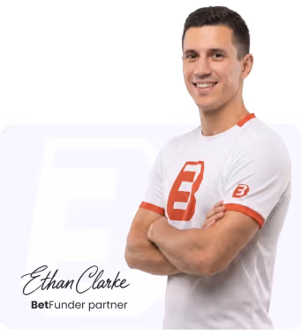 Ethan Clarke smiling with arms crossed wearing a white BetFunder partner t-shirt.