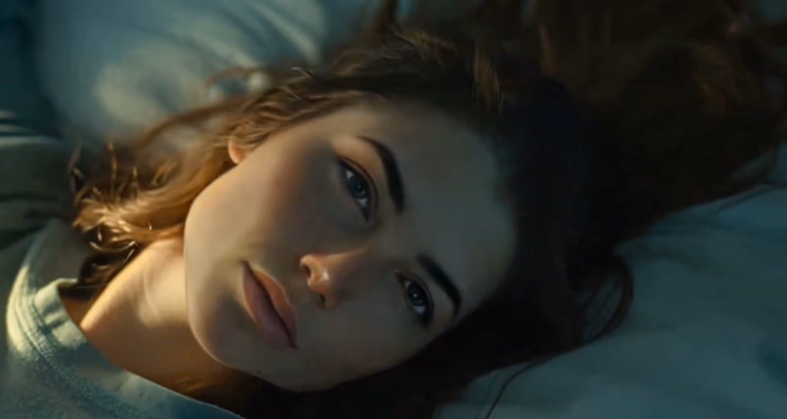 a young european girl lying on bed with a tired expression