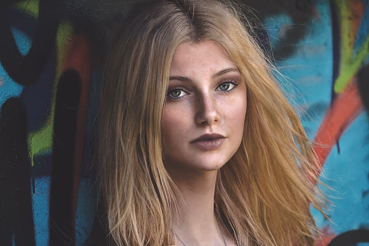a young blonde woman looking at the camera