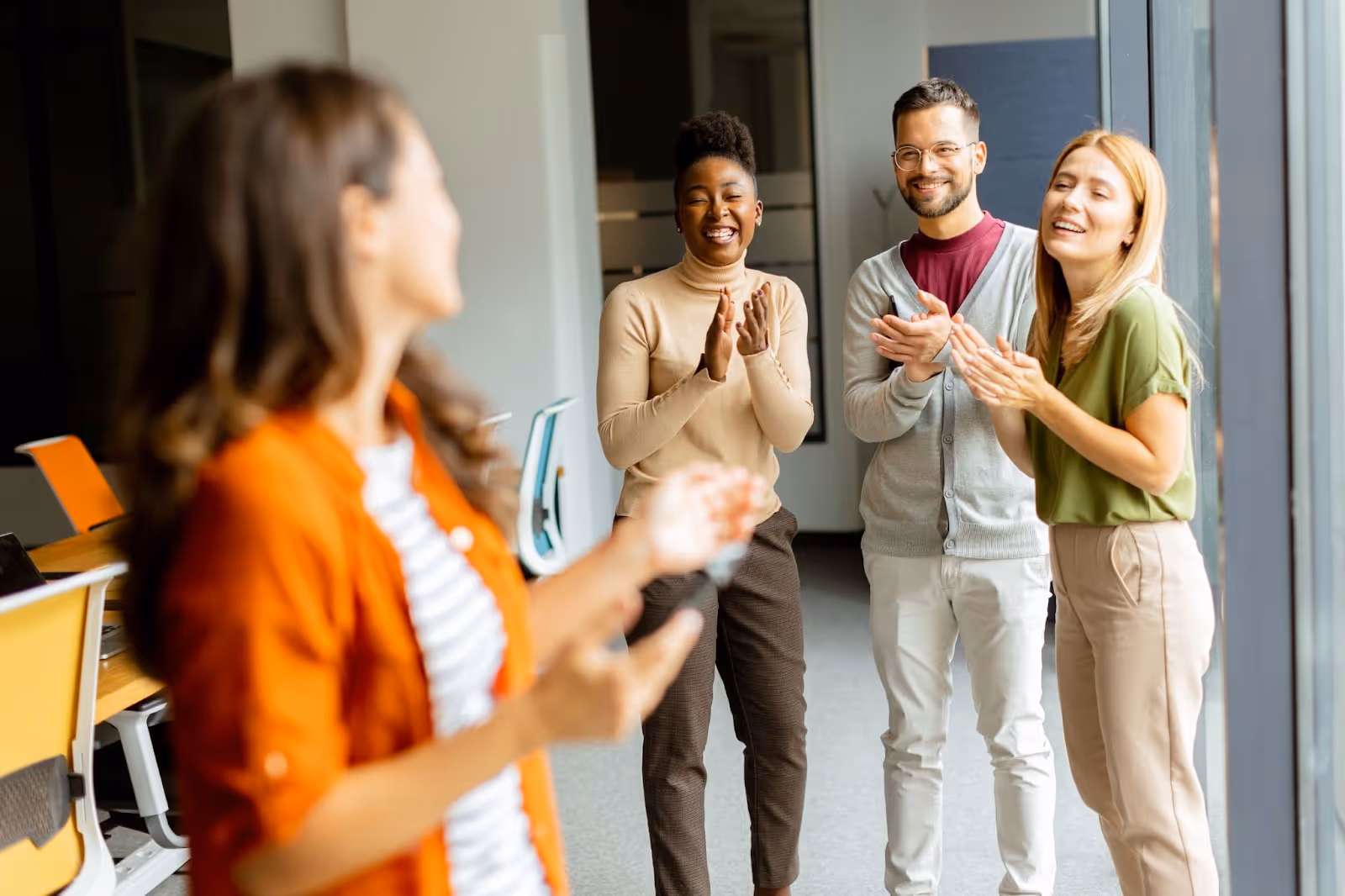 young business woman infront of her team members in the company