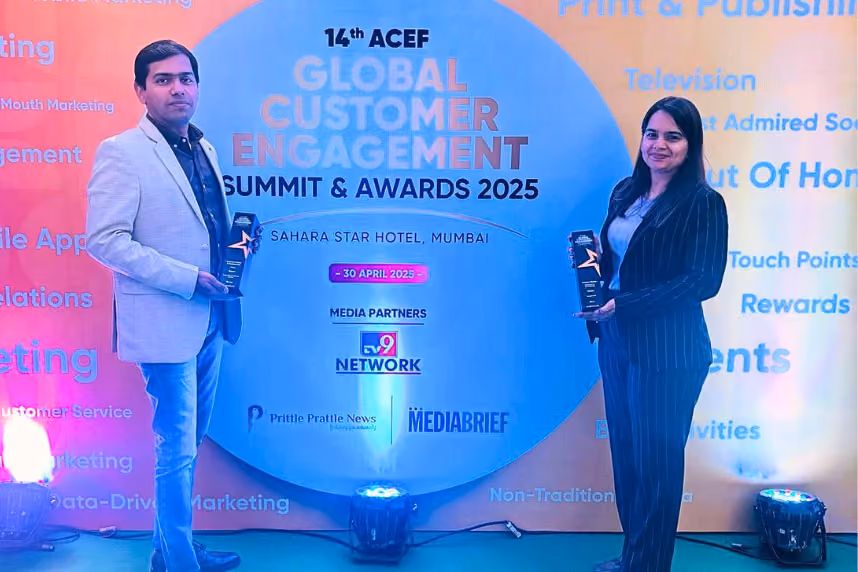 Two individuals holding awards standing in front of a backdrop for the 14th ACEF Global Customer Engagement Summit & Awards 2025 at Sahara Star Hotel, Mumbai.