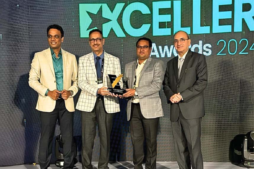 Four men standing on stage at Exceller Awards 2024; two middle men holding a trophy.