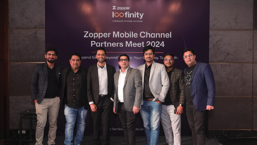 Seven men standing in a row in front of a purple banner that reads 'Zopper Mobile Channel Partners Meet 2024'.