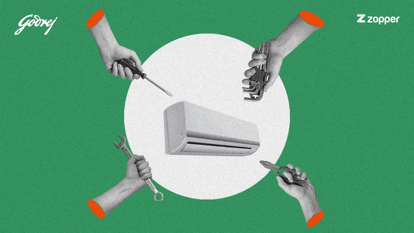 Four hands holding various tools around a central air conditioner unit against a green background with Godrej and Zopper logos.
