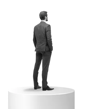 Man in a dark suit standing on a white cylindrical platform, facing away.