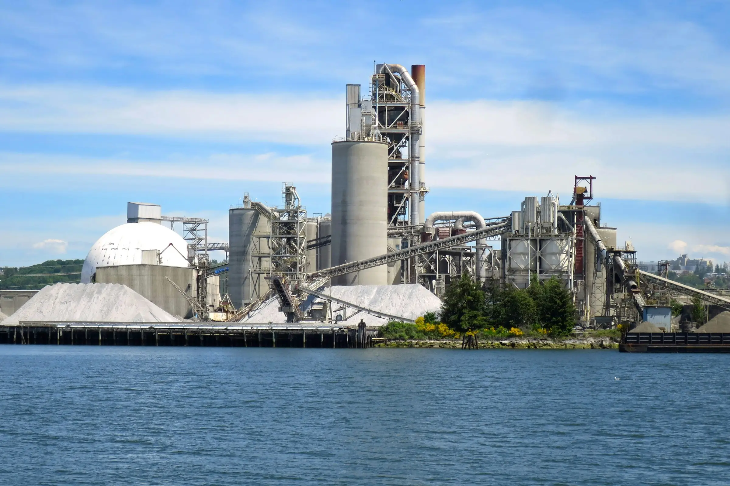Cement plant on the waterfront under a blue sky