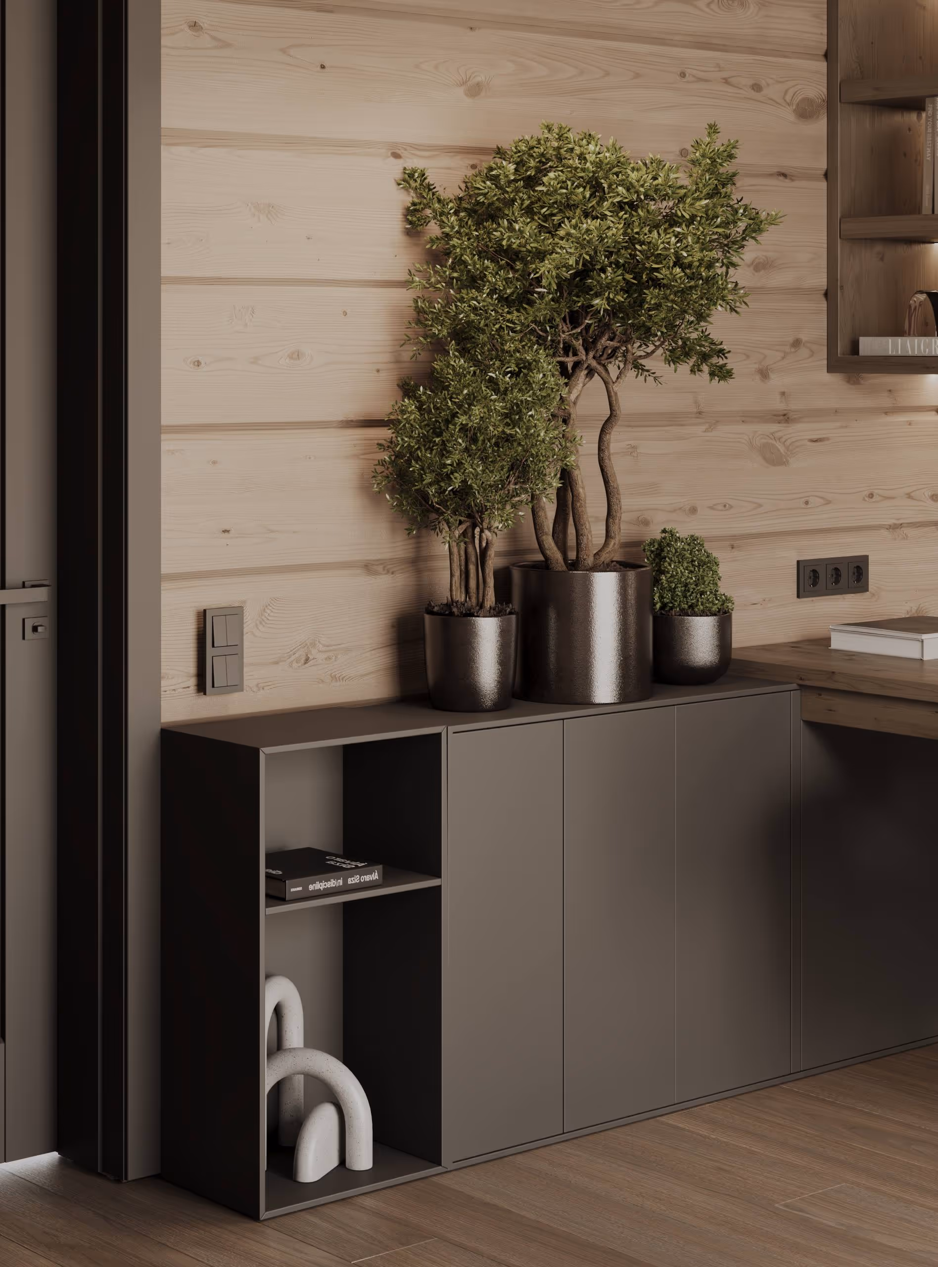 Минималистичный уголок в шале Alpen Traum — серая тумба, комнатные растения и деревянная отделка стены.