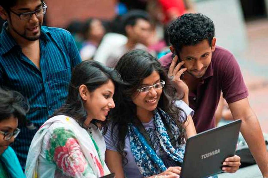 Students huddled around a laptop - Airwork