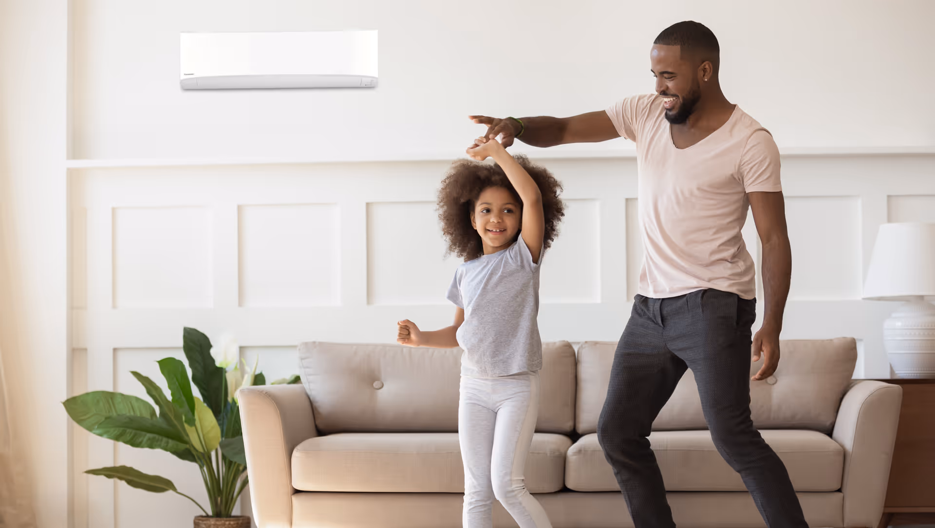 a man and a girl dancing in a living room