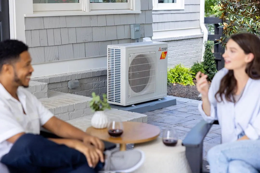 a man and woman sitting outside a heater