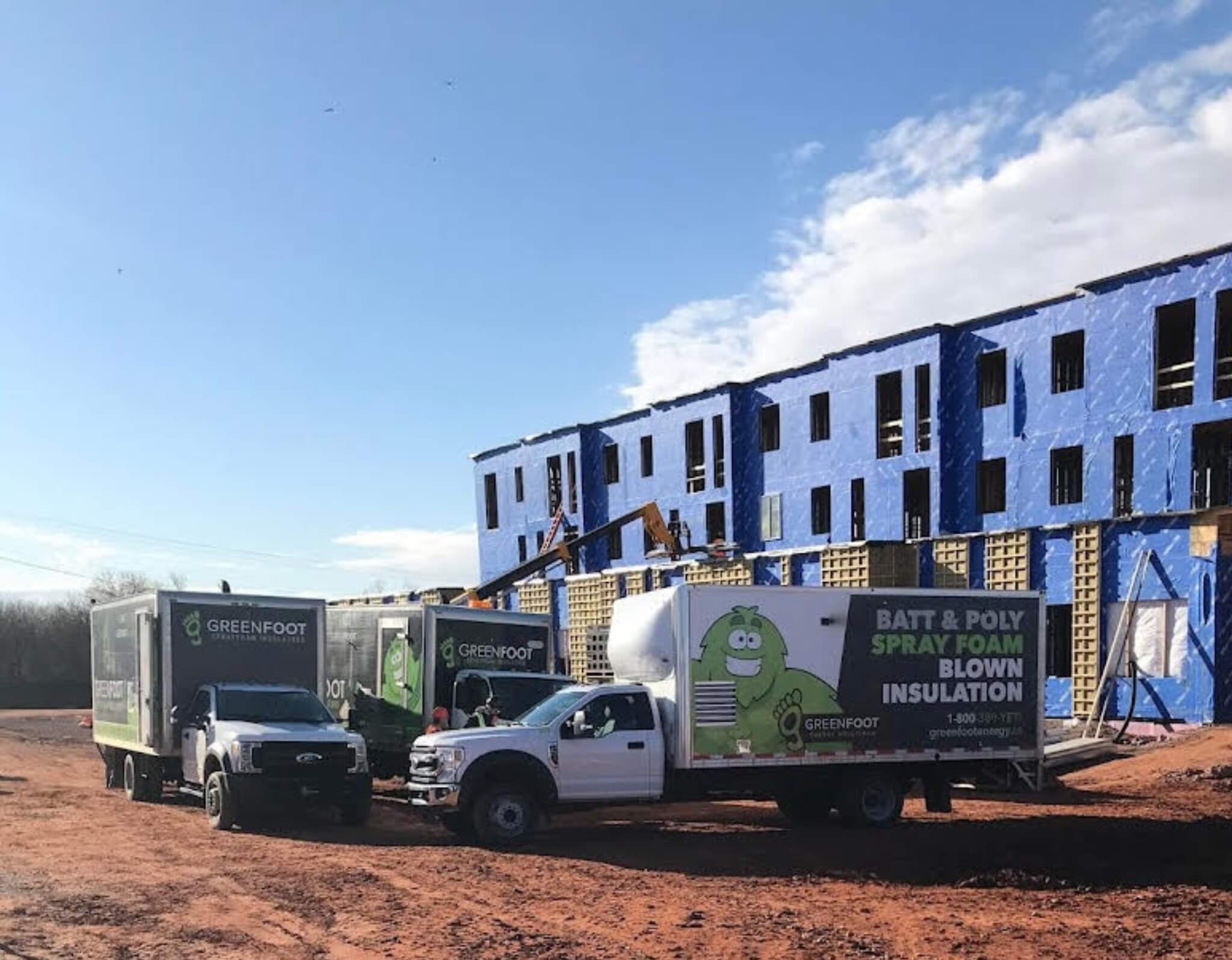 a truck and trailer parked in front of a building