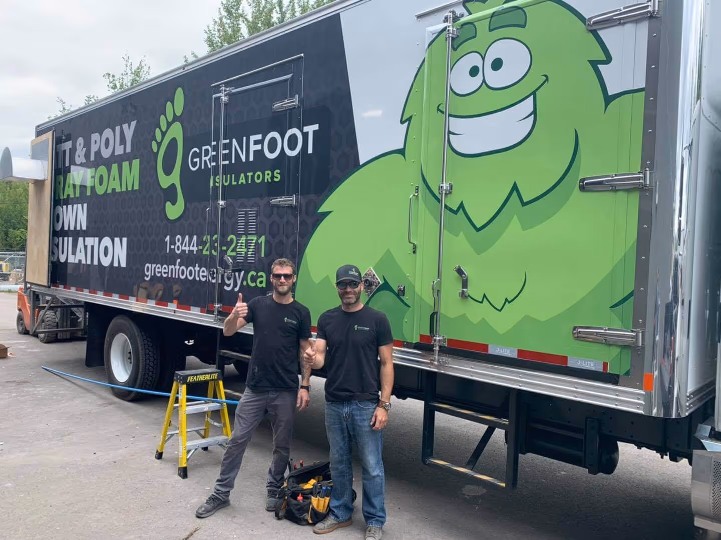 two men standing in front of a truck