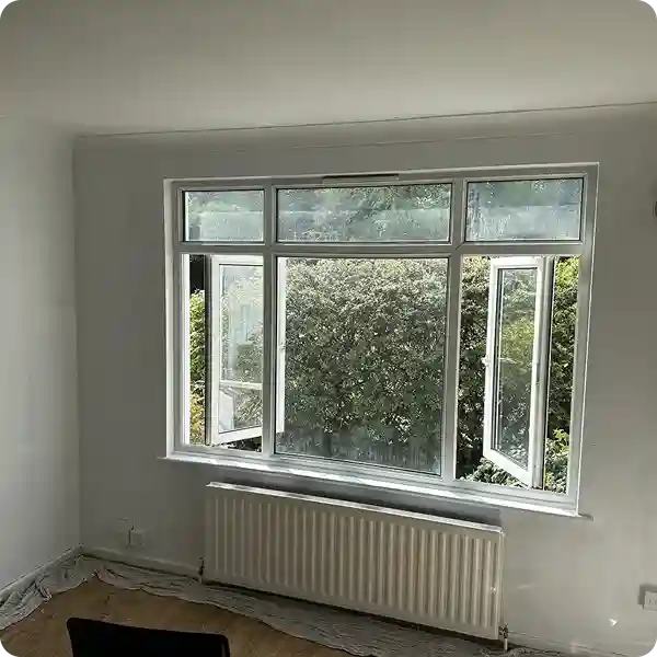 Bright and clean room after professional mould removal, with fresh-painted walls and no visible traces of mould